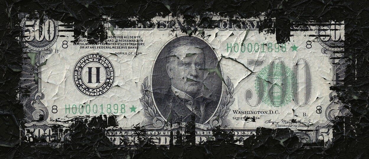 $500 bill fraying at the edges