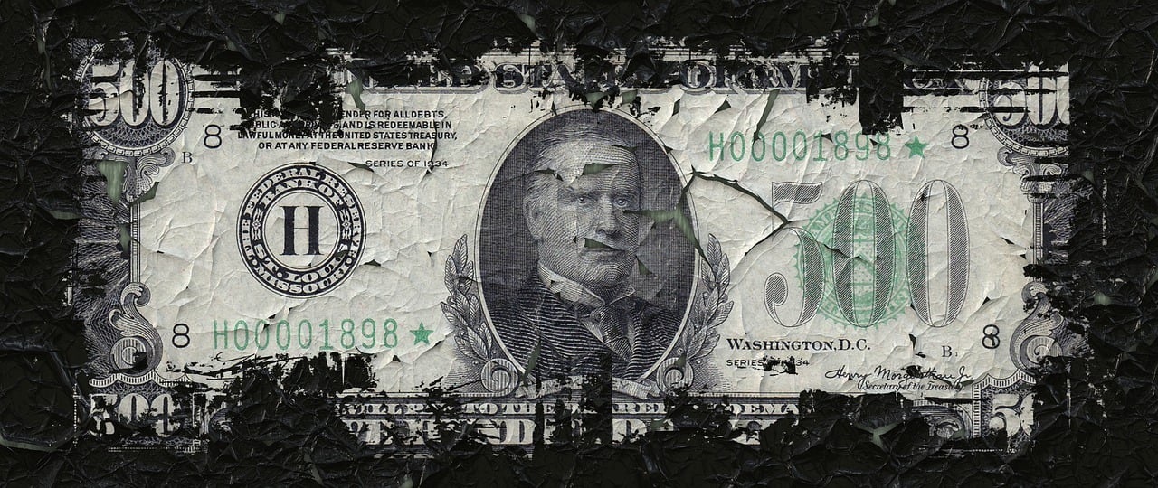 $500 bill fraying at the edges